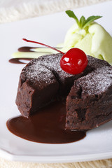 fondant cake with cherries and mint ice cream close-up. Vertical