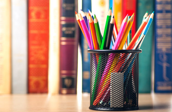 Colored pencils in pencil case on the bookshelf