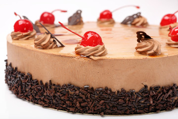 Coffee cake with cherry on white background