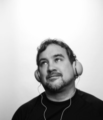 Caucasian Man wearing black shirt listening to DJ Style Headphon