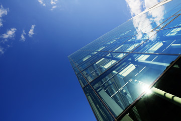 Modern building glass facade against sky