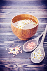 Body care and spa. Flowers in bowl with water and sea salt