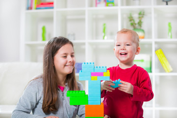 Obraz na płótnie Canvas Two children play with cubes