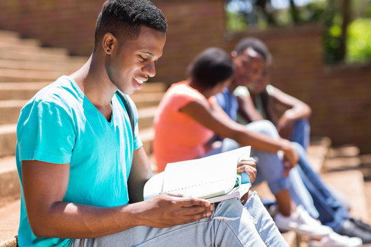 African American University Student Reading A Book