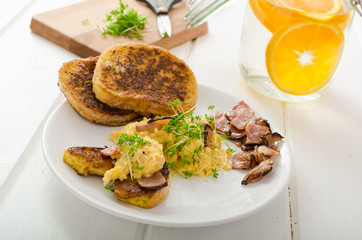 Scrambled eggs with French toast topped with watercress