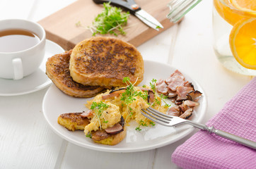 Scrambled eggs with French toast topped with watercress