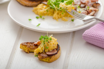 Scrambled eggs with French toast topped with watercress