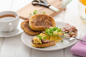 Scrambled eggs with French toast topped with watercress