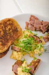 Scrambled eggs with French toast topped with watercress