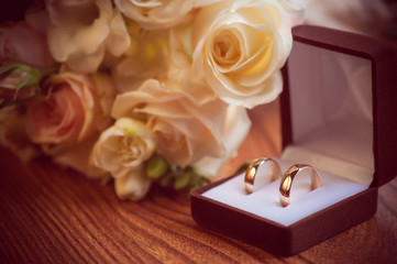 Wedding rings in a box and bridal bouquet