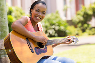 african american woman playing guitar