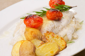 Fish dish - fish fillet in sauce and vegetables