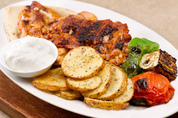 Grilled chicken fillets, with potatoes and vegetables