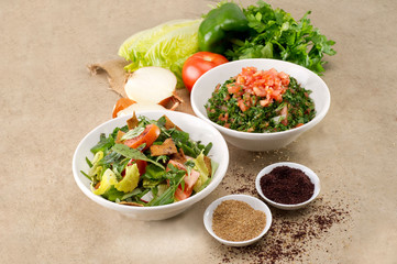 Plates of traditional Arabic salad fattouch and tabbouleh