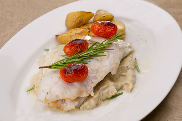 Fish dish - fish fillet in sauce and vegetables