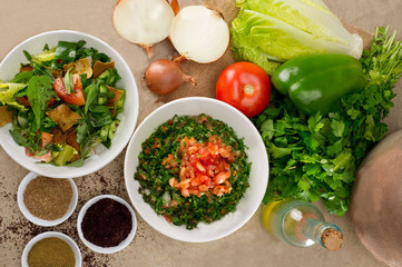 Plates of traditional Arabic salad fattouch and tabbouleh