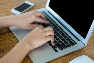 Closeup of business woman hand typing on laptop keyboard