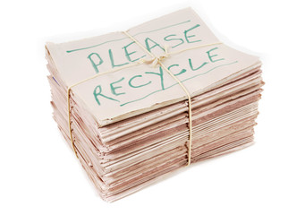 please recyle notice written on newspapers pile heap stack bundle tied with rope isolated white photo