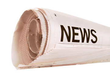 Rolled newspaper with news headline isolated white background photo