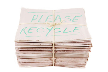 Please recyle notice written on newspapers pile heap stack bundle tied with rope isolated white photo