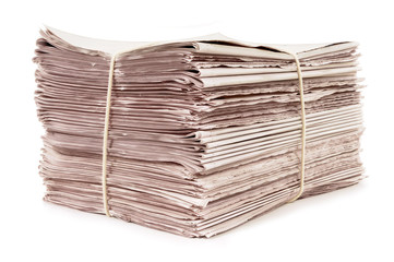 Bundle stack pile of newspapers tied with rope for delivery isolated white background