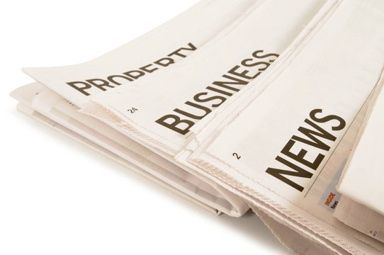 Newspaper headlines property business news stacked various isolated white background photo
