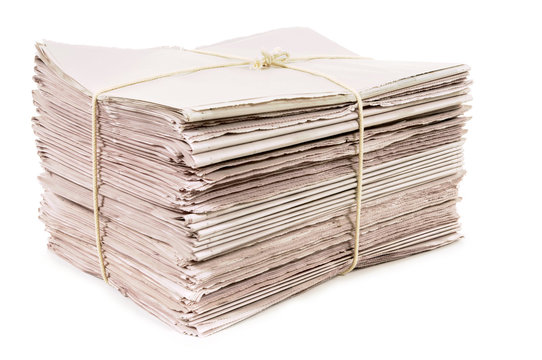 Bundle stack pile of newspapers tied with rope for delivery isolated white background