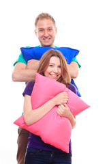 Fototapeta premium Boy and girl holding colorful pillows