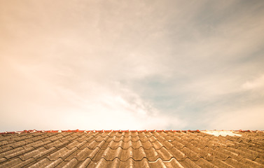 Cloudy sky over the asbestos roof tiles
