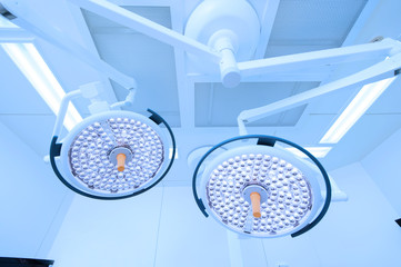 Two surgical lamps in operation room take with blue filter