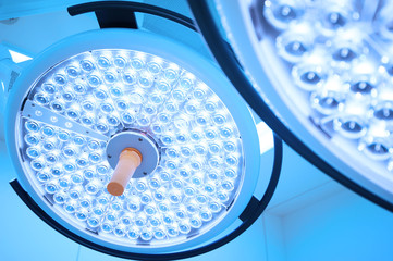 Two surgical lamps in operation room take with blue filter
