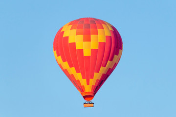 Fototapeta na wymiar A hot air balloon flying on a clear sky day.