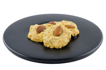 Almond cookies on black dish with clipping path