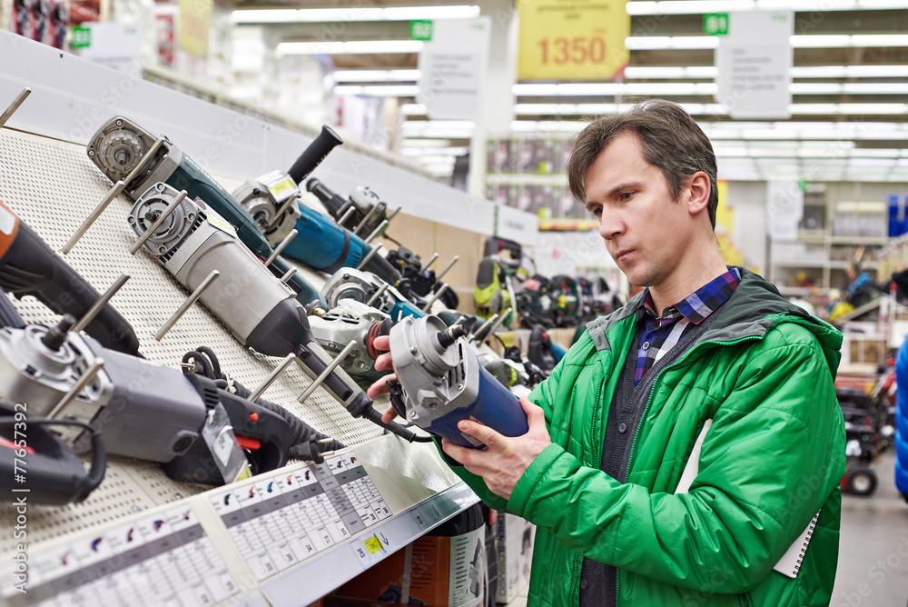 Wall mural Man shopping for sander in hardware store