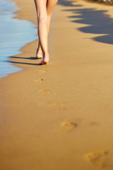 Closeup of legs of a woman on the beach