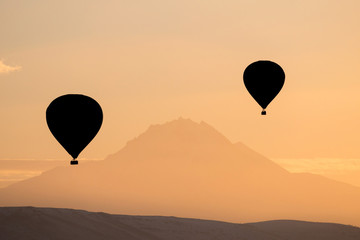 Silhouette of hot air balloons fly over Cappadocia.