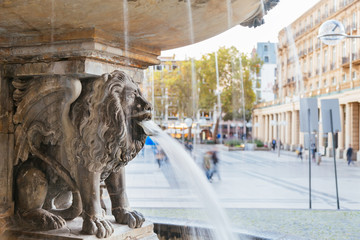 Lion statue and fountain on the square near Cologne cathedral