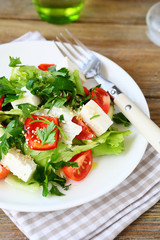 Salad with tomatoes, peppers and cheese on a plate