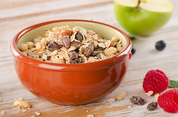 muesli breakfast with fresh berries and green apple