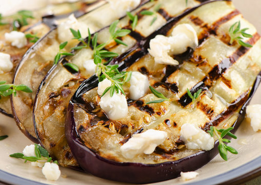 Grilled eggplant slices on a plate.