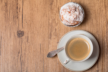 Top view on cup of coffee and muffin