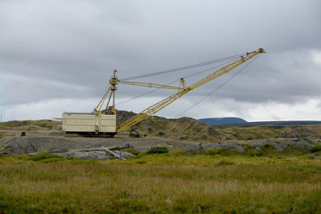 Old abandoned walking excavator .