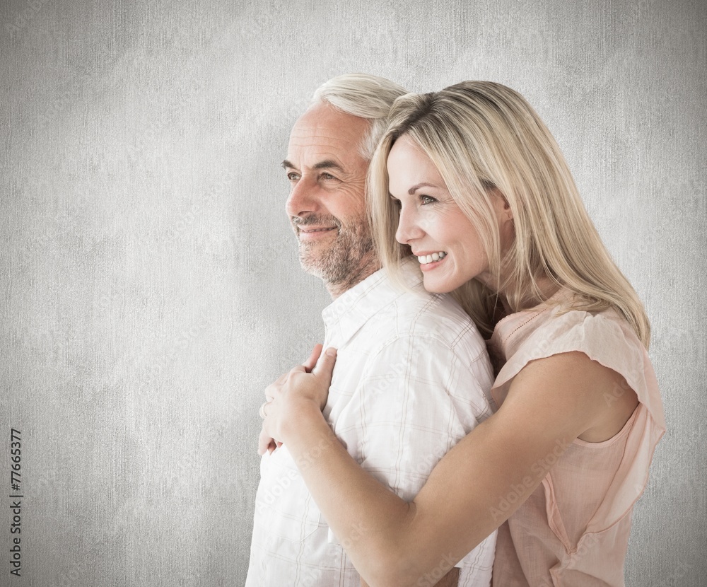 Poster Composite image of affectionate couple standing and hugging