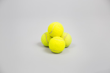 Yellow tennis balls on a grey background