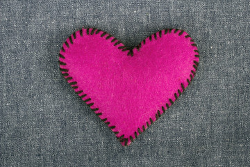 pink heart on blue fabric background