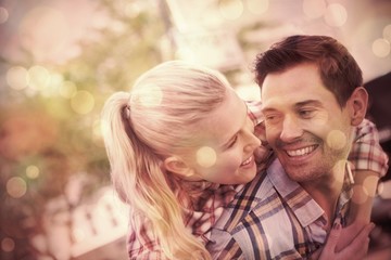 Fototapeta premium Man giving his pretty girlfriend a piggy back