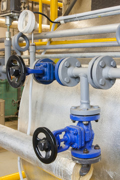 Pipes and faucet valves of heating system in a boiler room