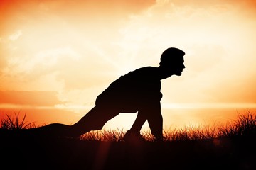 Naklejka premium Side view of a young man in ready to run post