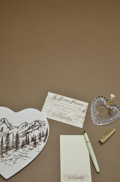 Writing a letter, hearts and a brown background
