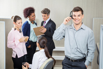 Happy Male Customer Service Representative Using Headphones